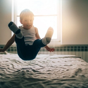 Estimulación temprana para bebés y niños niño saltando sobre la cama