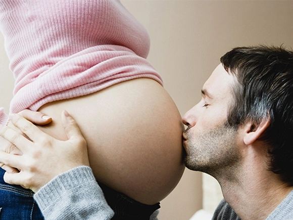 Presencia del padre en estudios prenatales hombre besando la panza de su esposa
